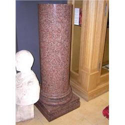 A 19th century granite cylindrical column turned with stepped rings above the two tier square plint.