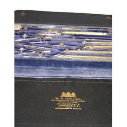 W H Harling, 117 Moorgate, London EC2, a geometry set in leatherette folding wallet, two pens among.