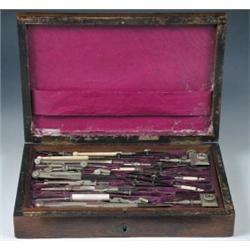 A Victorian brass inlaid rosewood cased geometry set, the well figured rectangular lid with brass l.