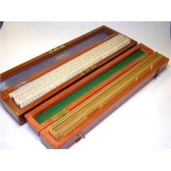 Two early 20th century mahogany cased sets of rulers or scales, the 'Stanley' set with boxwood cent.
