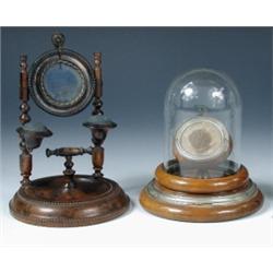 Two early 20th century turned wood watch stands, the earlier held between turned columns with pin c.