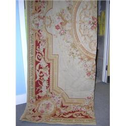 A 20th century Aubusson style tapestry woven with floral medallion within ochre cartouche and deep..