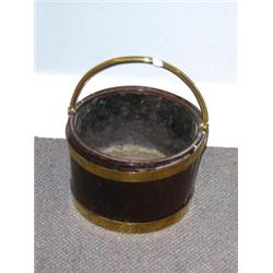 An early 19th century brass bound mahogany bucket, the tapering cylindrical sides with two brass ba.