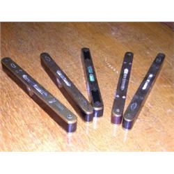 Five brass mounted hardwood spirit levels, each of the slender rectangular shapes with rounded ends.
