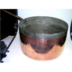 A late 19th century copper saucepan with tinned interior, brazed seams and iron handle, 31cm diamet.