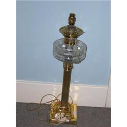 A late Victorian brass oil lamp, later converted for electricity, the cut clear glass receiver on r.