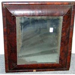 A late Stuart walnut cushion framed mirror, the later rectangular plate within oyster veneers and o.