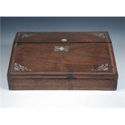A mid 19th century rosewood writing slope, the hinged fall sloping away from a lid covering compart.