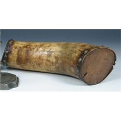 An 18th/19th century French Canadian buffalo horn flask, the two ends stopped with wood secured by..