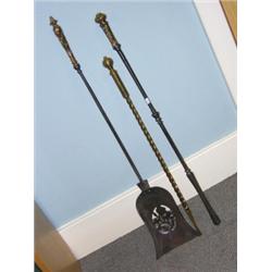 Three various fire irons, to include: a 19th century steel shovel with foliate bronze handle, a pok.