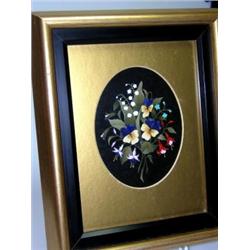 A 20th century pietra dura oval panel worked in lapis lazuli and coloured stones with fuchsia, pans.