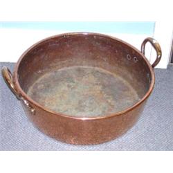 A late Victorian copper preserve pan, the rounded cylindrical sides and roll over rim flanked by tw.