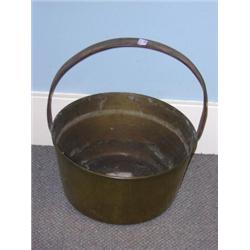 A late 19th century brass preserve pan, the tapering cylindrical sides below a fixed iron strap han.