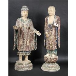 Two 18th century and later Chinese carved and painted wooden figures, both of their blue lined mauv.
