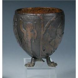A late 18th/early 19th century coconut cup carved in low relief with Daniel in the lion's den, a he.