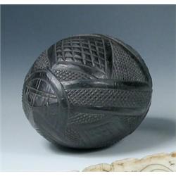 A 19th century 'Bug bear' carved coconut, the eyes and open mouth of the mask at one end of the geo.