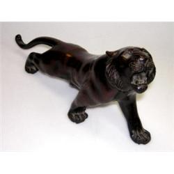 An early 20th century Japanese bronze tiger, signed Sei(?)ya, the feline roaring from a stalking po.