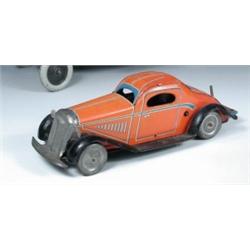 A British made tinplate clockwork model sedan car, the orange body with lithographed detail, the bo.