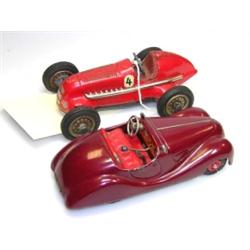 An early Schuco Studio 1050 clockwork Mercedes racing car, red painted, numbered '4', and a later E.