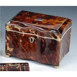 An early Victorian tortoiseshell tea caddy, the rectangular lid with wavy front and back and closin.
