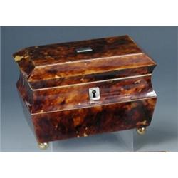 An early Victorian tortoiseshell tea caddy, the sarcophagus shape with veneers separated by white m.