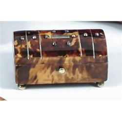 A Victorian tortoiseshell trinket casket, the lid inset with facetted iron studs and slightly arche.