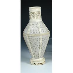 A 19th century Canton ivory vase, the downswept shoulders and tapering hexagonal body formed of vei.