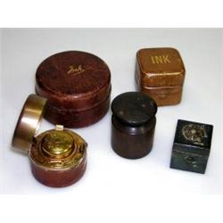 Four mid Victorian leather bound travelling inkwells and another Bakelite, one 'Made in Austria', a.