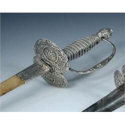 An 18th century Toulouse silver mounted dress sword in shagreen scabbard, the handle bound in herri.