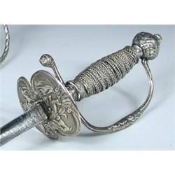 An 18th century French parcel gilt mounted dress sword, the bicusped guard and pommel chased with h.