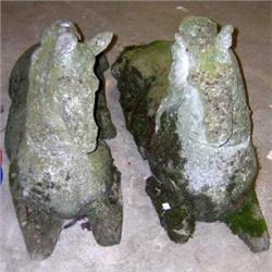 A pair of 20th century composition figures of horses, they recline and wear a crown around their ne.