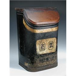 A mid 19th century japanned tea canister, the black rectangular sectioned sides rounded at the fron.