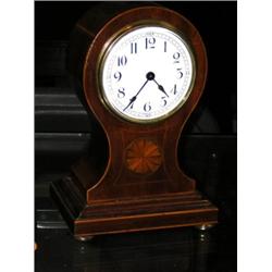 An early 20th century mahogany cased balloon clock, the French eight day movement with platform esc.