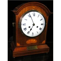 An early 20th century mahogany cased German mantel clock, the eight day movement chiming on two coi.