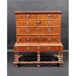 An 18th century and later walnut oyster veneered chest on stand, the upper section with parquetry i.
