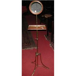 A 19th century shaving stand, the circular plate within a moulded frame supported on an adjustable..