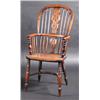 Image 1 : A 19th century yew wood and elm Windsor armchair, the arched spindle turned back with pierced splat.