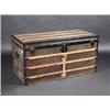 Image 1 : A Louis Vuitton trunk, the banded rectangular rising top enclosing a fitted interior above a simila.