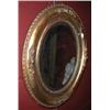 Image 1 : A pair of 19th century gilt framed mirrors, each with oval bevelled plate within a carved moulded f.