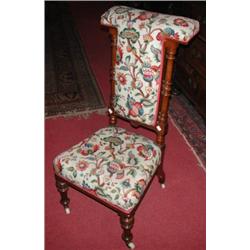 A Victorian walnut framed prie dieu chair, the padded top rail above a padded back flanked with tur.