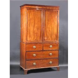 A Regency mahogany linen press, the upper section with moulded cornice above a pair of panelled doo.