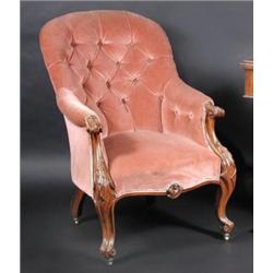 An early Victorian walnut framed armchair, the arched button padded back above downswept scrolling..