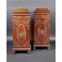 A pair of George III style mahogany dining pedestals, each with arched top with carved edge above a.