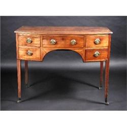 A George III mahogany bow front side board, the shaped top with reeded edge above five short drawer.