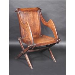 An oak Glastonbury chair, of typical construction  £200-300...