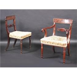 A set of six Regency mahogany dining chairs including a single carver, each with bowed top rail abo.