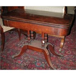 A Regency mahogany pedestal card table, the crossbanded rounded rectangular baize lined fold over t.