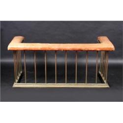 A leather upholstered brass club fender, of typical construction, 144cm wide  £300-500...