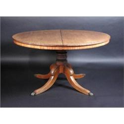 A Regency mahogany extending dining table, the circular top above a plain frieze supported on a tur.
