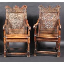 A matched pair of oak Wainscot chairs, one 17th century, each with scroll carved arched top rail ab.